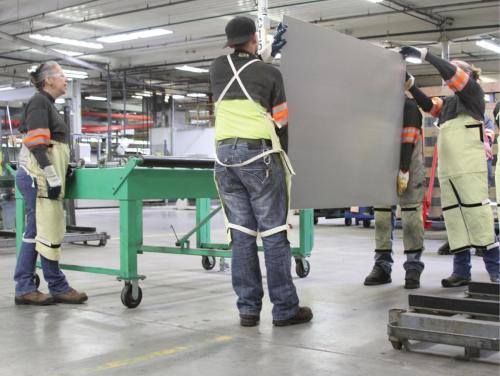 A group of new Viracon, viracon.com, employees being taught how to safely handle and lift glass.