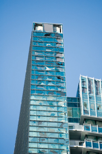 high rise building with hurricane damaged windows