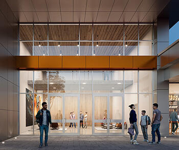 an exterior view of a glass entrance to a building with glass windows extending above a metal cross beam and four people standing outside the sliding doors